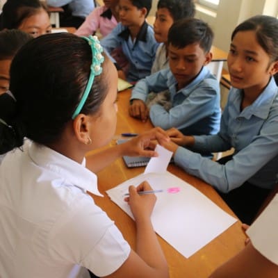 A female student leader hosts a session with students in Cambodia.