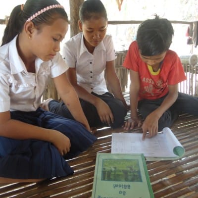 Kids work on a lesson for class in Cambodia.