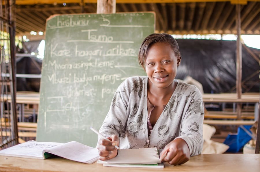 Rumbi smiles for a photo in her classroom.