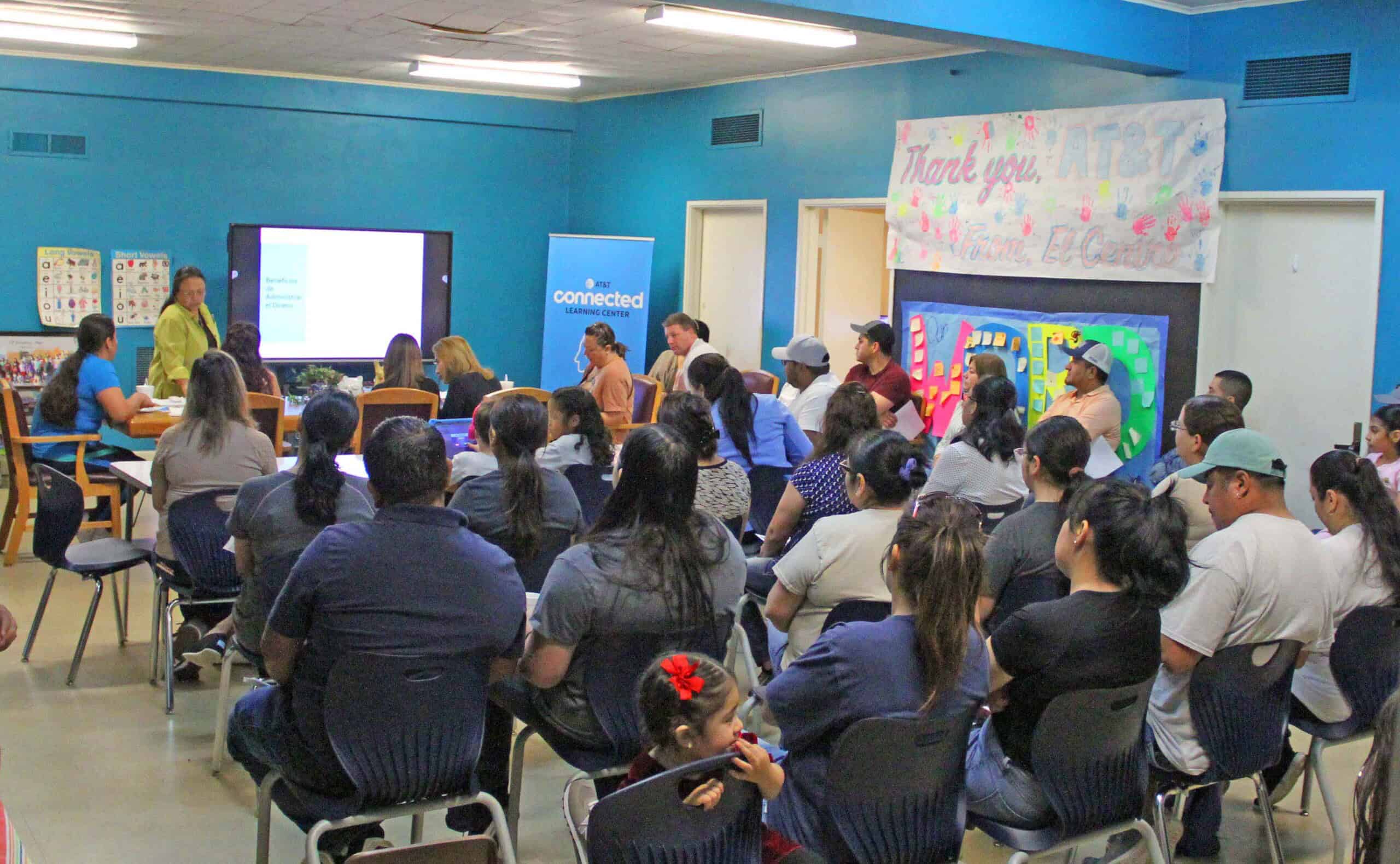 A group of students in a financial literacy workshop and device distribution event