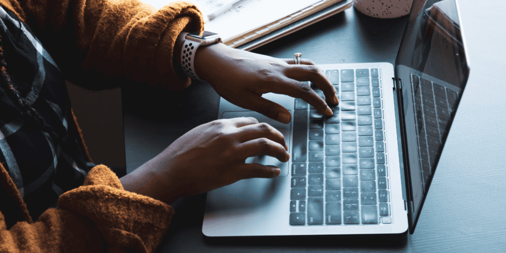 A woman typing on a laptop